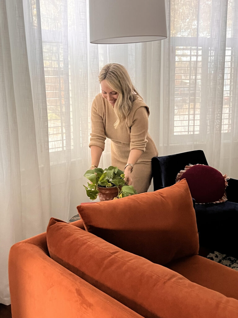  A cozy Airbnb bedroom with soft lighting, layered textiles, and calming decor.