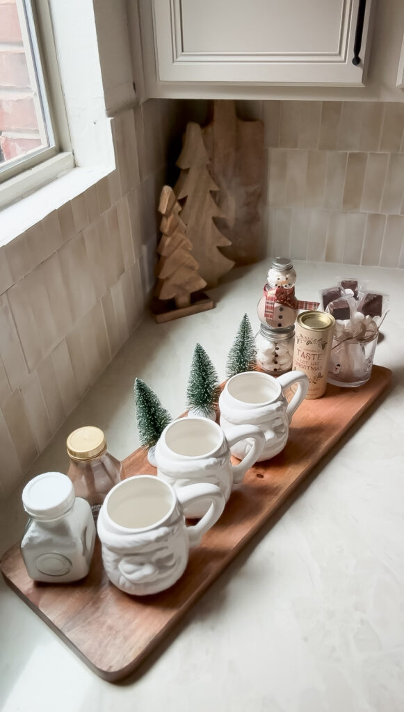 A cozy hot cocoa bar set up with a variety of toppings, including marshmallows, whipped cream, and candy canes, perfect for holiday gatherings