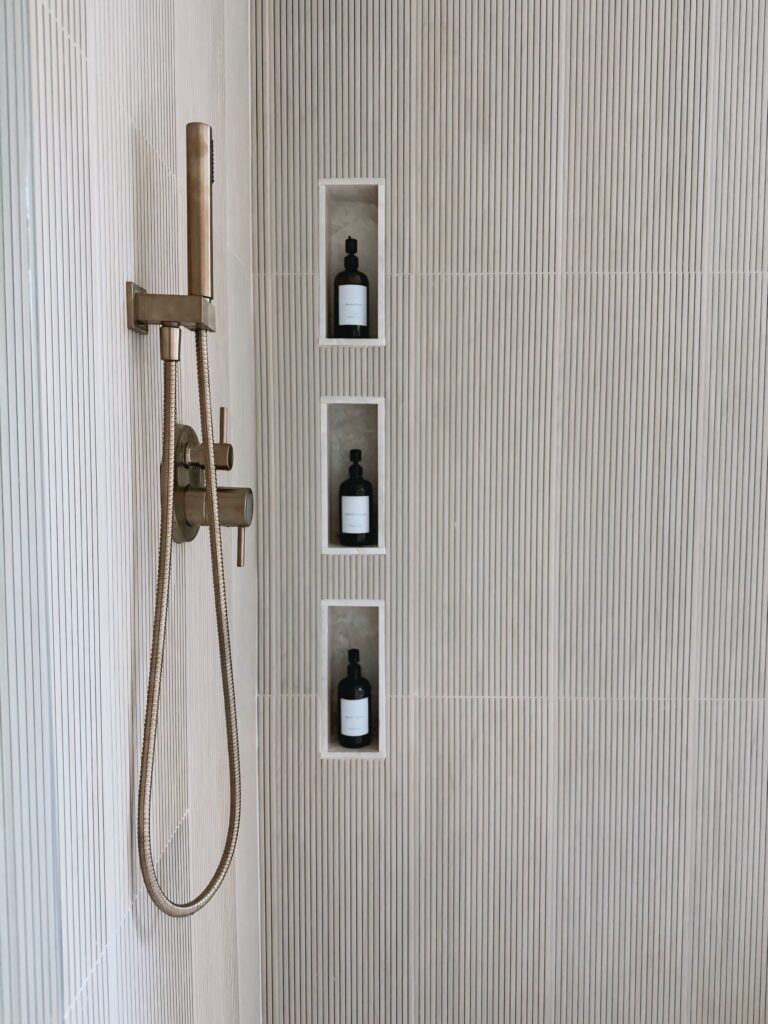 New bathroom shower remodel featuring a Delta faucet, showcasing a spa-like design with modern fixtures and sleek finishes.